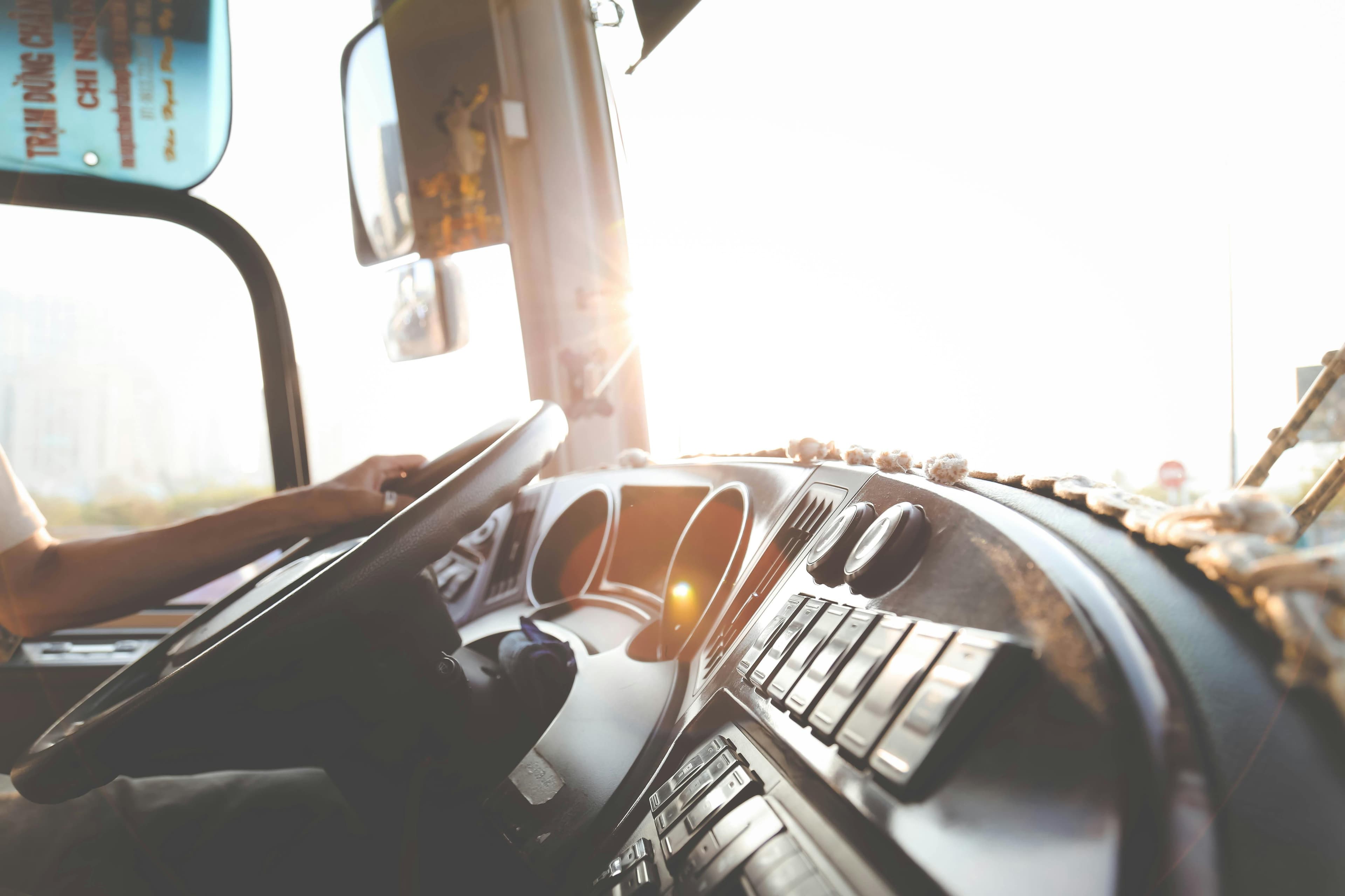 A student reviewing CDL training from a phone beside a truck